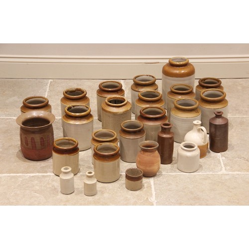 584 - A collection of twenty five assorted glazed stoneware jars and pots, the largest 27cm high