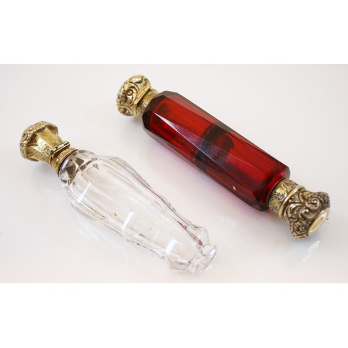 24 - A red glass Victorian scent bottle, the embossed scrolling terminal with red glass faceted body, 13c... 