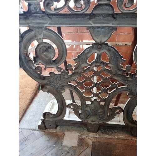 578 - A Victorian Coalbrookdale style cast iron hall stand, of arched form, with eight scrolled hooks, the... 