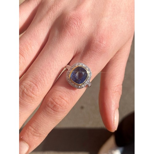 226 - A certified Burmese sapphire and diamond cluster ring, the central cushion cut sapphire (6.05 carats... 