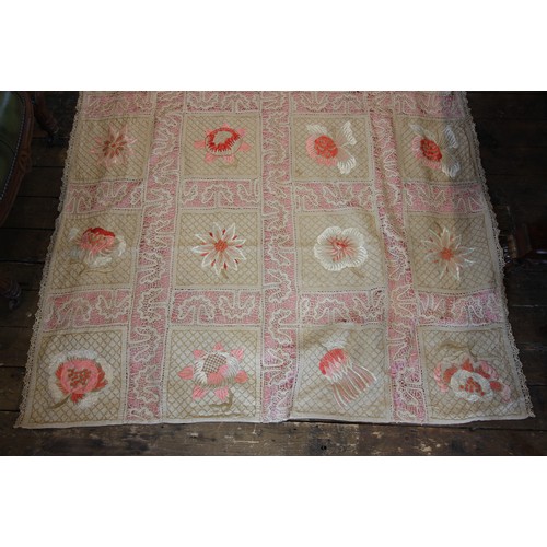 609 - An early 20th century quilt, comprised of twenty four florally embroidered panels in pink and red to... 