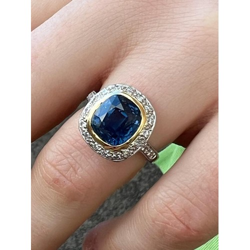 226 - A certified Burmese sapphire and diamond cluster ring, the central cushion cut sapphire (6.05 carats... 