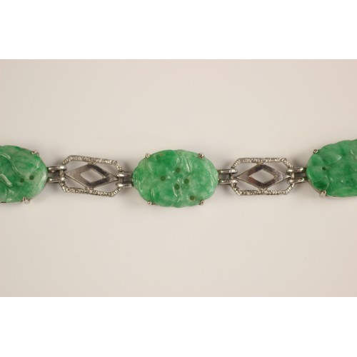 222 - A jade panel bracelet, the five carved jade panels modelled with floral decoration interspersed with... 