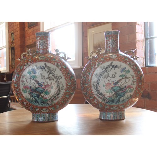 437 - A large pair of Chinese porcelain moon flasks, 19th century (Xianfeng / Tongzhi), each centrally dec... 