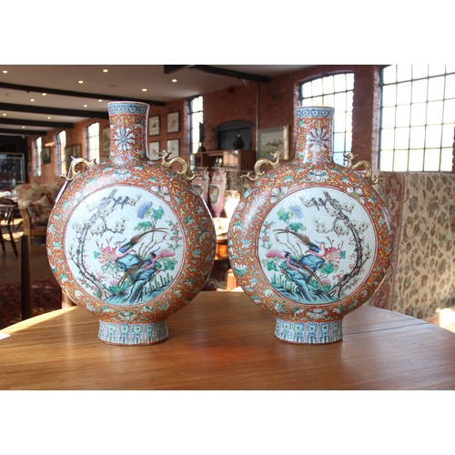 437 - A large pair of Chinese porcelain moon flasks, 19th century (Xianfeng / Tongzhi), each centrally dec... 