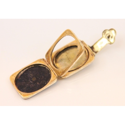 106 - A Victorian enamel and yellow metal locket, the rectangular locket with black enamel decoration and ... 