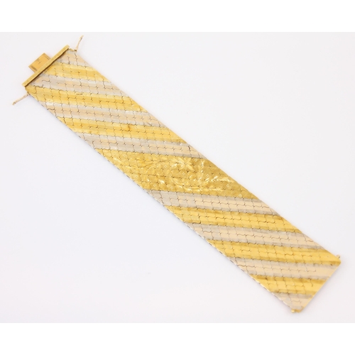 107 - A two tone yellow and white metal bracelet, the flat link bracelet with yellow and white metal strip... 