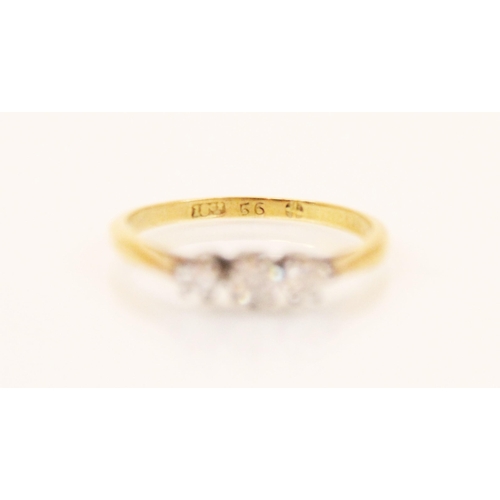 131 - An Edwardian style three stone diamond ring, the central round cut diamond with graduated round cut ... 