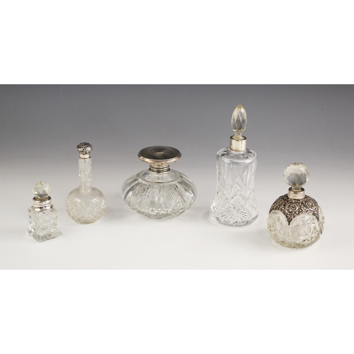 14 - A selection of silver mounted scent bottles, including a Moody & Archer, Birmingham 1975, the pull-o... 