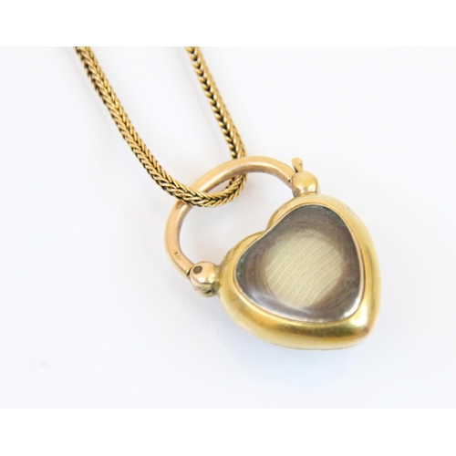 193 - An untested amethyst heart shaped locket/clasp, the cabochon heart amethyst in a yellow metal plain ... 