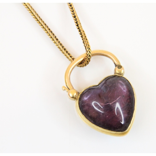 193 - An untested amethyst heart shaped locket/clasp, the cabochon heart amethyst in a yellow metal plain ... 