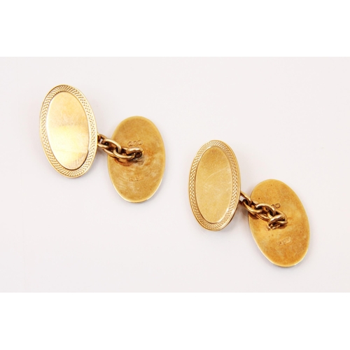 200 - A cased set of yellow metal cufflinks, the oval links with engraved border and plain polished centre... 