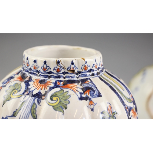 396 - A near pair of French faience jars and covers, 20th century, of lobed inverted baluster form, the co... 