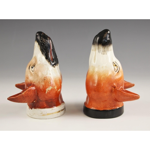 418 - A pair of Staffordshire stirrup cups, 19th century, each naturalistically modelled as a fox mask, on... 