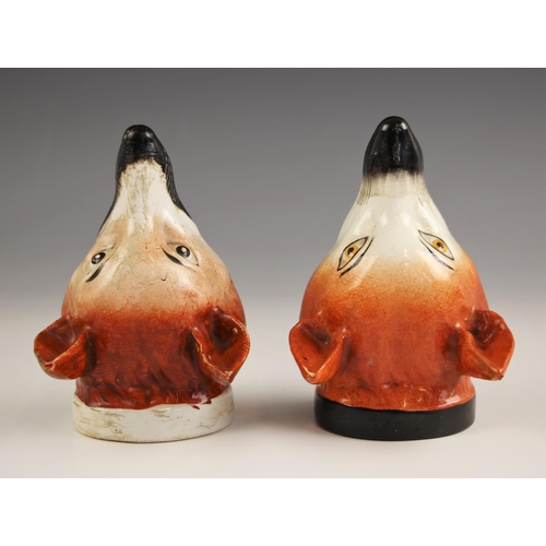 418 - A pair of Staffordshire stirrup cups, 19th century, each naturalistically modelled as a fox mask, on... 