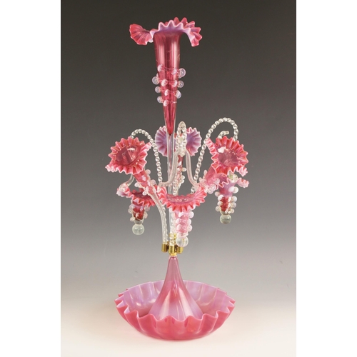 498 - A cranberry glass epergne of typical form, with central trumpet over three lower trumpets, and three... 