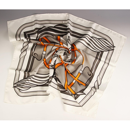 574 - An Hermes silk scarf, in the Quadridge II pattern designed by Pierre Peron, in grey and orange, with... 