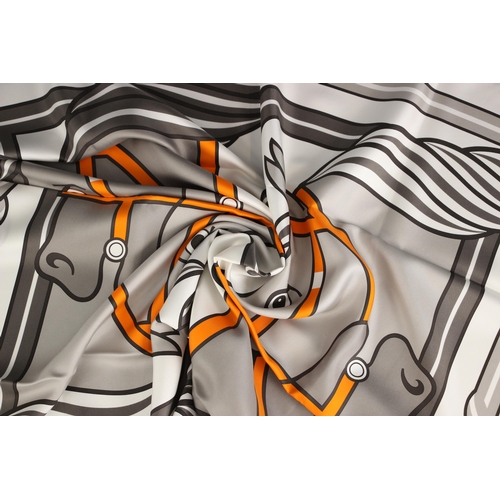 574 - An Hermes silk scarf, in the Quadridge II pattern designed by Pierre Peron, in grey and orange, with... 