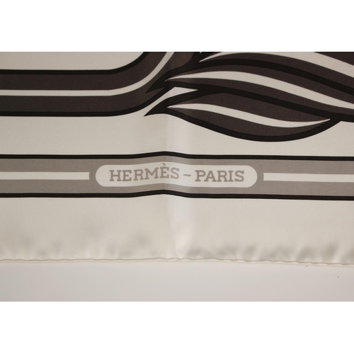 574 - An Hermes silk scarf, in the Quadridge II pattern designed by Pierre Peron, in grey and orange, with... 