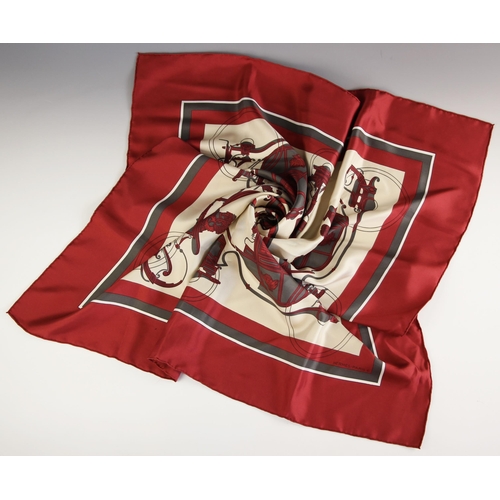 577 - An Hermes silk scarf, in the 'Ex Libris' pattern designed by Hugo Grygkar, in wine and grey, with ro... 