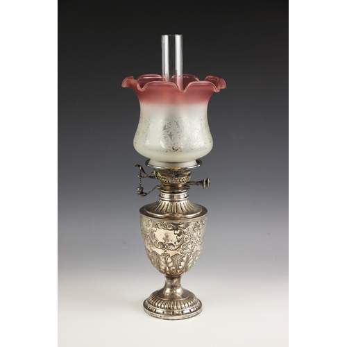 6 - A Victorian silver oil lamp, James Deakin and Sons, Sheffield 1891, the urn shaped body with embosse... 