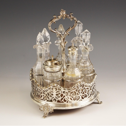 60 - An Elkington and Co silver plate cruet set, the cast foliate handle above a pierced border and woode... 