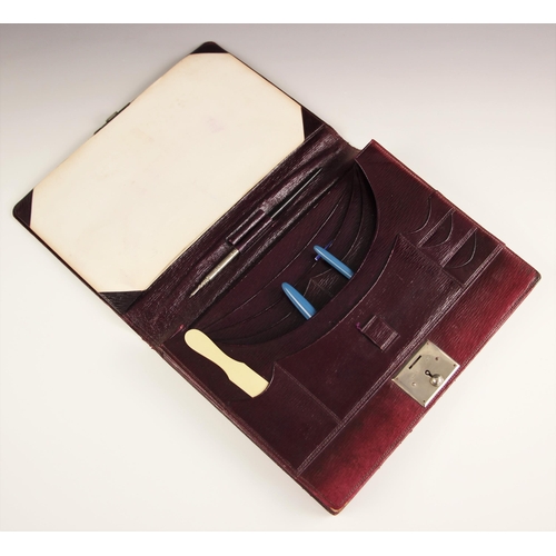 634 - A burgundy leather writing case, 20th century, of typical form, with a Sheaffer pen and propelling p... 