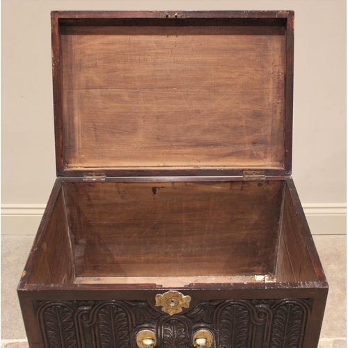 714 - A George III mahogany cellarette, of rectangular hinged form, the front panel carved with lunette fl... 