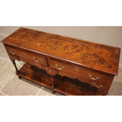 731 - A George III style figured elm pot board dresser, 20th century, the high back with a moulded cornice... 