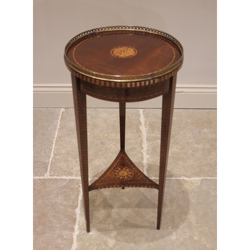 750 - A 19th century mahogany inlaid plant stand, the circular top with an openwork brass gallery, centred... 