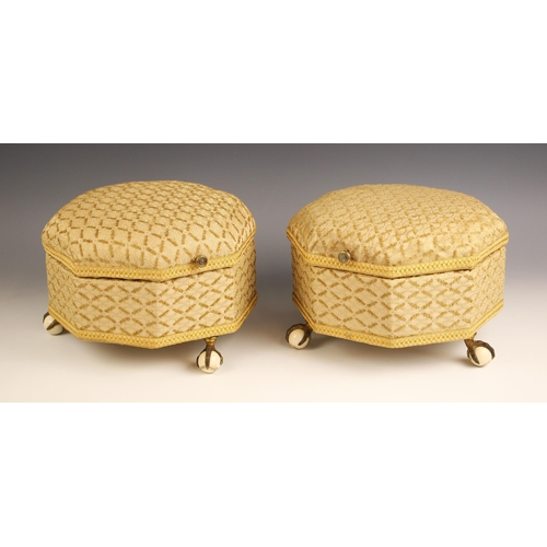 775 - A pair of Victorian upholstered octagonal footstools, with hinged covers, upon three brass claw and ... 