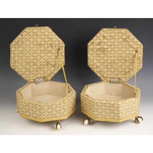 775 - A pair of Victorian upholstered octagonal footstools, with hinged covers, upon three brass claw and ... 