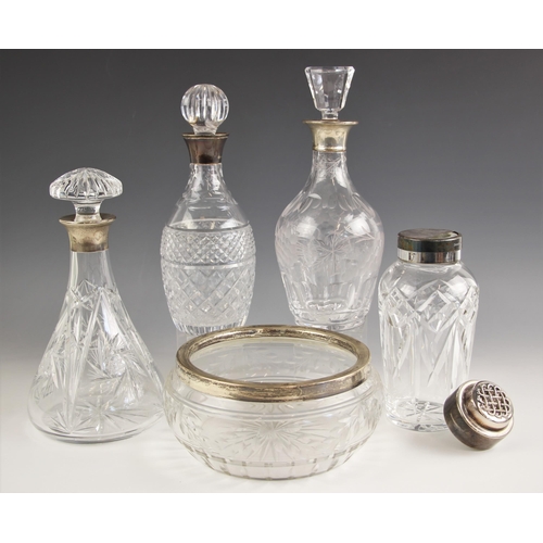 9 - A selection of silver collared glass decanters, to include a tapered glass decanter, B P Co, London ... 