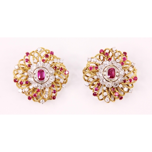 105 - A pair of ruby and diamond lapel brooches, the central cushion cut rubies within a surround of old c... 