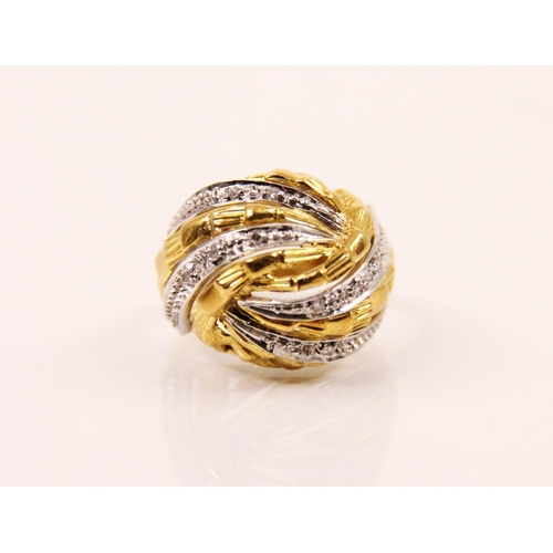 111 - A diamond and two tone bombe cocktail ring, the yellow and white metal striped design ring with plan... 