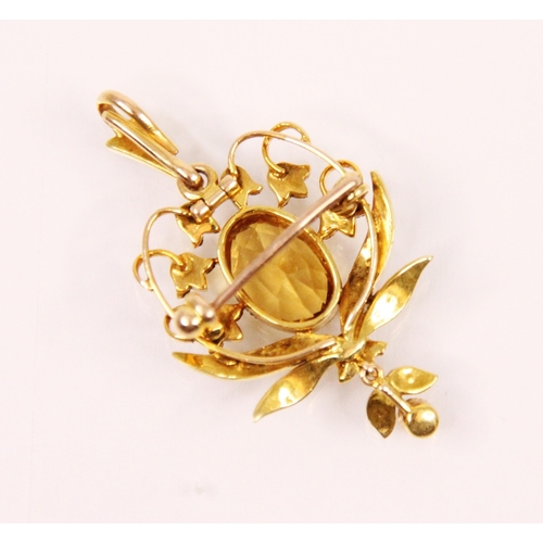 114 - An Edwardian citrine and seed pearl pendant brooch, the oval cut citrine within a snow drop designed... 