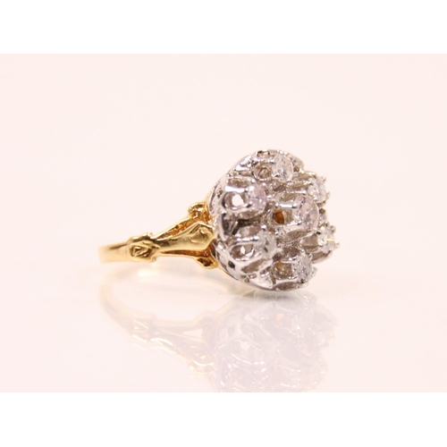 150 - A late 20th century diamond cluster ring, the central round cut diamond with a surround of six furth... 