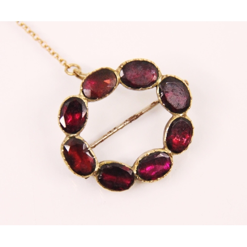 162 - An early 20th century garnet brooch, designed as eight continuous oval cut garnets in circular desig... 