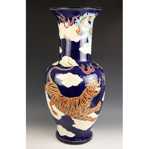 331 - A large Chinese floor vase, 20th century, the baluster shaped vase decorated with a tiger and a drag... 