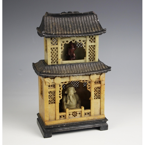 335 - A Chinese carved soapstone pagoda, late 19th century, the sectional shrine carved with internal deit... 