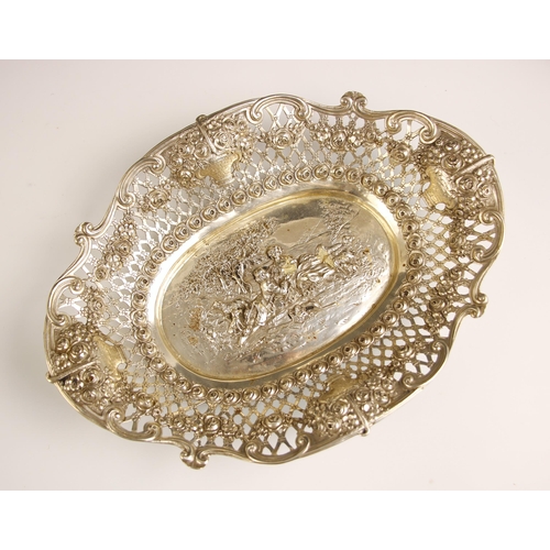 4 - A Continental silver coloured dish, the pierced foliate border with four floral embossed basket deco... 