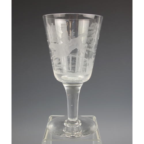 516 - A glass chalice, early 20th century, the funnel bowl wheel cut with continuous hunting scene, on tap... 