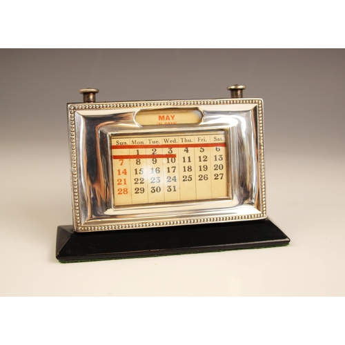 52 - A silver mounted desk top perpetual calendar, W J Myatt & Co, Birmingham 1952, the plain polished mo... 