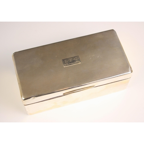 54 - A George V silver mounted cigarette box, William Neale and Son, Birmingham 1927, the hinged cover wi... 