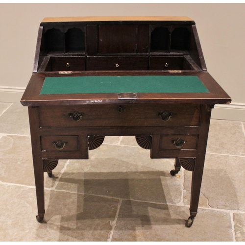 736 - A late George III oak bureau on stand, the hinged fall front opening to an arrangement of small draw... 