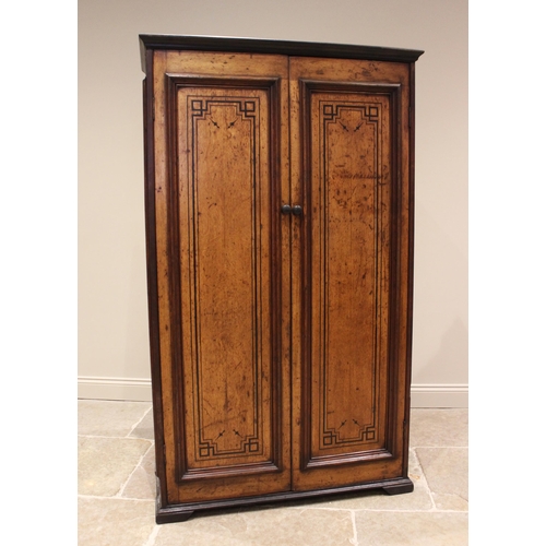 769 - An Aesthetic Movement honey oak hall cupboard, late 19th century, the moulded and ebonised cornice o... 