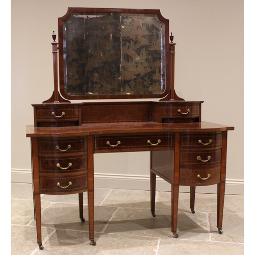 772 - An Edwardian mahogany dressing table by Warings, of inverted breakfront form, with a pair of small c... 