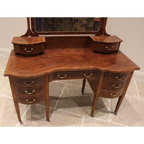 772 - An Edwardian mahogany dressing table by Warings, of inverted breakfront form, with a pair of small c... 