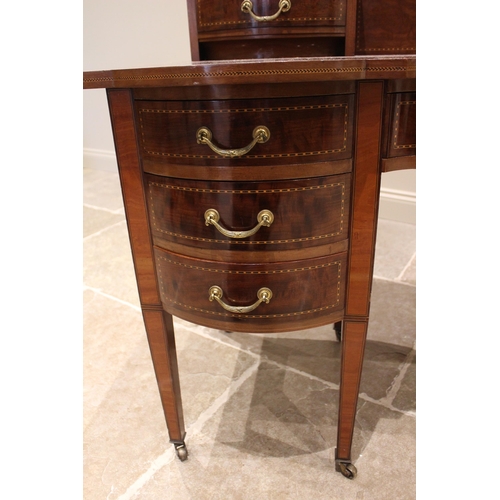 772 - An Edwardian mahogany dressing table by Warings, of inverted breakfront form, with a pair of small c... 