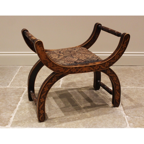 779 - A stained wood and penwork 'X' frame stool, late 19th century, the curved frame applied with trailin... 